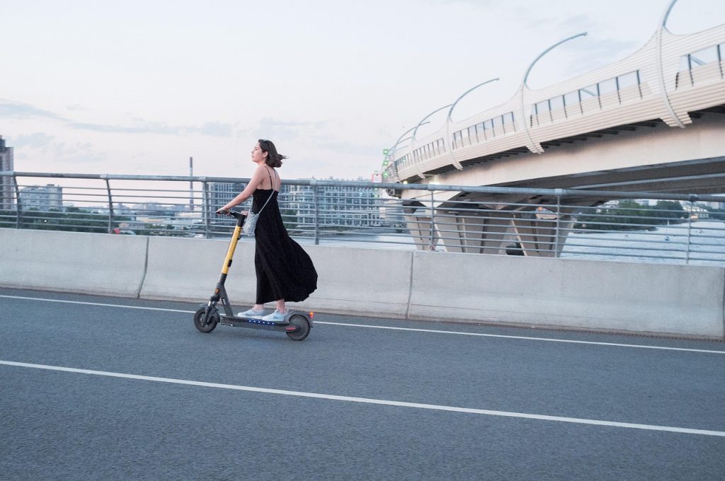 Woman, electric scooter, street — How Lilpepe Presale Gives Early Investors a Chance to Participate in Community Growth